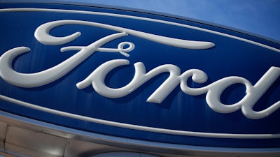 This Oct. 24, 2021 file photo shows a Ford company logo on a sign at a Ford dealership in southeast Denver.