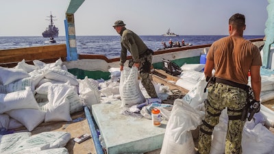 In this photo released by the U.S. Navy, sailors inventory urea and ammonium perchlorate found on a dhow intercepted in the Gulf of Oman on Nov. 9, 2022.