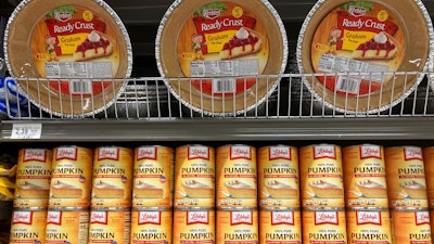 Canned pumpkin and graham cracker shell crusts are displayed at a Publix Supermarket, Tuesday, Nov. 16, 2021 in North Miami, Fla. Americans are bracing for a costly Thanksgiving this year, with double-digit percent increases in the price of turkey, potatoes, stuffing, canned pumpkin and other staples.