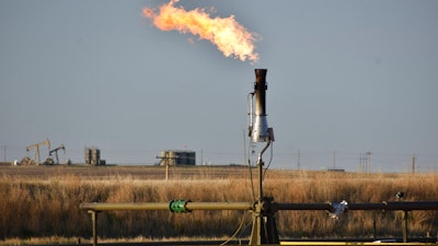 A flare for burning excess methane, or natural gas, from crude oil production, is seen at a well pad east of New Town, N.D., May 18, 2021. The Interior Department on Monday, Nov. 28, 2022, proposed rules to limit methane leaks from oil and gas drilling on public lands, the latest action by the Biden administration to crack down on emissions of methane, a potent greenhouse gas that contributes significantly to global warming.