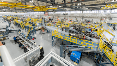 Sikorsky employees building CH-53K aircraft utilizing 3-D work instructions, new titanium machining centers with multi-floor ergonomic platforms.