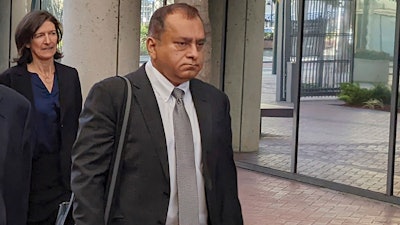 Ramesh 'Sunny' Balwani, right, the former lover and business partner of Theranos CEO Elizabeth Holmes, walks into federal court in San Jose, Calif., on June 24, 2022.