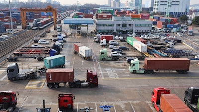 Container trucks run at the Inland Container Depot in Uiwang, South Korea, Dec. 9, 2022.
