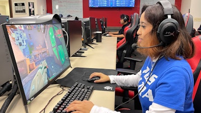 Lethrese Rosete, a 20-year-old DePaul sophomore who is majoring in UX design to combine her creativity and coding skills, plays an online game at the university's Esports Gaming Center Thursday, Sept. 22, 2022, in Chicago. A growing effort to channel students' enthusiasm for esports toward preparing them for jobs in science, technology, engineering and math could improve racial diversity in STEM.