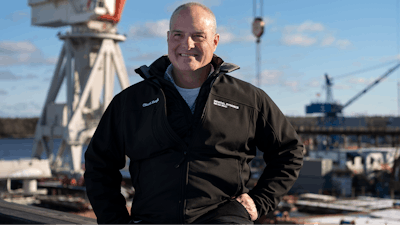 Charles F. Krugh, president of Bath Iron Works, poses at the shipyard Tuesday, Dec. 20, 2022, in Bath, Maine. The former Gulfstream Areospace executive and U.S. Army veteran oversees a workforce that builds destroyers for the Navy.