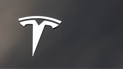 The Tesla company logo is seen on the hood of an unsold vehicle at a dealership, Aug. 9, 2020, in Littleton, Colo.