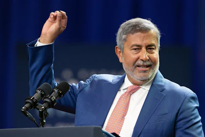 Sanjay Mehrotra, CEO of Micron Technology, holds up a microchip as he gives a speech about his company's planned investment in microchip manufacturing in upstate New York at Onondaga Community College on Thursday, Oct. 27, 2022, in Syracuse, N.Y.