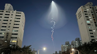 The light trail is seen in Goyang, South Korea, Friday, Dec. 30, 2022. South Korea's military confirmed it test-fired a solid-fueled rocket on Friday, after its unannounced launch triggered brief public scare of a suspected UFO appearance or a North Korean missile or drone flying.