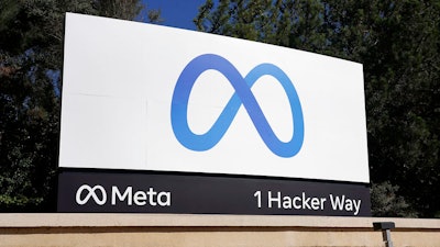 Facebook's Meta logo sign is seen at the company headquarters in Menlo Park, Calif. on Oct. 28, 2021. Federal regulators open their campaign to block Facebook parent Meta’s acquisition of virtual-reality company Within Unlimited and its fitness app Supernatural, with opening arguments beginning Thursday, Dec. 8, 2022, in San Jose, California.