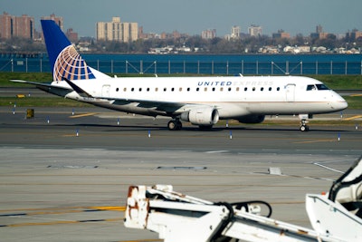 A United Airlines plane at LaGuardia Airport's Terminal B, Tuesday, Nov. 22, 2022, in New York. Travel experts say the ability of many people to work remotely is letting them take off early for Thanksgiving or return home later. Crowds are expected to rival those of 2019, the last Thanksgiving before the pandemic.