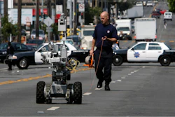 A police officer uses a robot to investigate a bomb threat in San Francisco, on July 25, 2008.