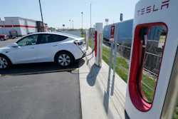 A Tesla charges at a station in Topeka, Kan., Monday, April 5, 2021. Tesla says it sold a record 1.3 million electric vehicles in 2022.
