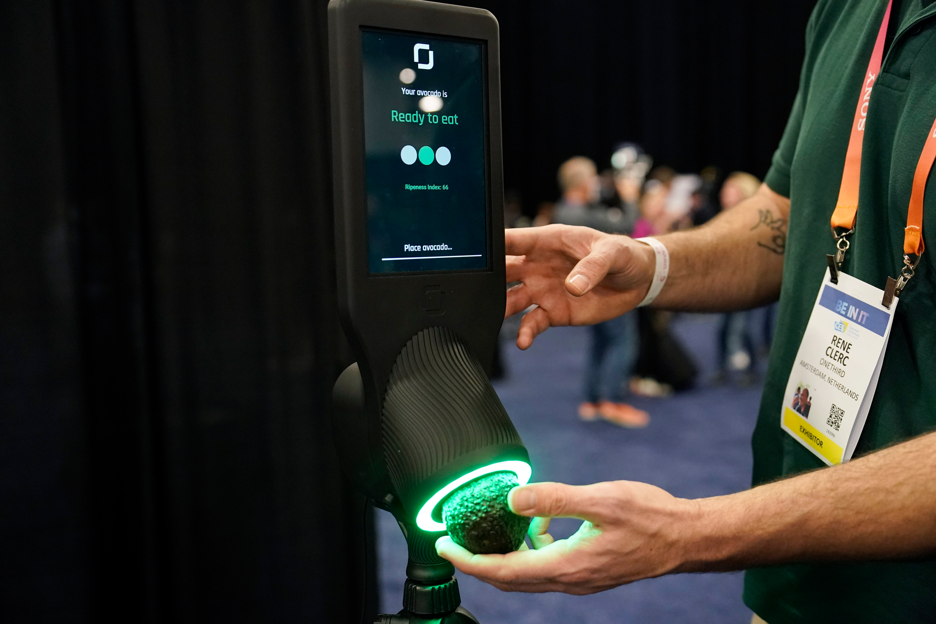 An exhibitor demonstrates the OneThird avocado ripeness checker during CES Unveiled before the start of the CES tech show, Tuesday, Jan. 3, 2023, in Las Vegas.