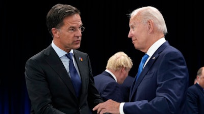 Netherland's Prime Minister Mark Rutte, left, speaks with U.S. President Joe Biden during a round table meeting at a NATO summit in Madrid, Spain, June 29, 2022.