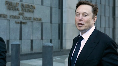 Elon Musk leaves the Phillip Burton Federal Building and United States Court House in San Francisco, Tuesday, Jan. 24, 2023. Musk returned to federal court to defend himself against a class-action lawsuit that alleges he misled Tesla shareholders with a tweet about an aborted buyout that the billionaire defiantly insisted Tuesday he could have pulled off, had he wanted.