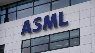 The logo of ASML, a leading maker of semiconductor production equipment, hangs on the head office in Veldhoven, Netherlands, Monday, Jan. 30, 2023.