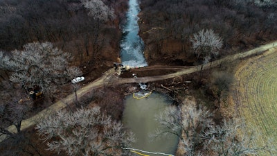 In this photo taken by a drone, cleanup continues in the area where the ruptured Keystone pipeline dumped oil into a creek in Washington County, Kan., Dec. 9, 2022.
