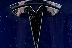 A Tesla electric vehicle emblem is affixed to a passenger vehicle Sunday, Feb. 21, 2021, in Boston.