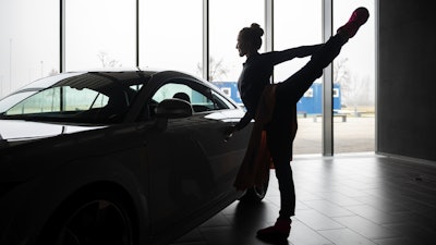 A ballet dancer warms up before an open rehearsal at the Audi automobile factory in Gyor, Hungary, Thursday, Feb 16, 2023.