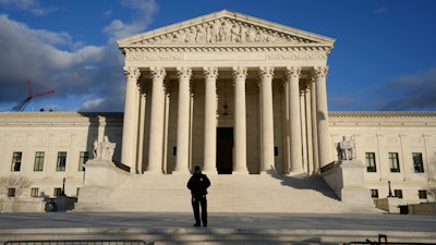 Security stands outside the U.S. Supreme Court, Jan. 20, 2023, in Washington.