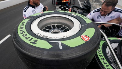 Tires made from natural rubber derived from a desert shrub, sit on a cart before the pit stop contest ahead of the Indianapolis 500 auto race at Indianapolis Motor Speedway, Friday, May 27, 2022, in Indianapolis.