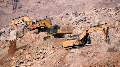 In this photo released by China's Xinhua News Agency, rescuers with heavy equipment work at the site of a collapsed open pit coal mine in Alxa Banner in northern China's Inner Mongolia Autonomous Region, Friday, Feb. 24, 2023.