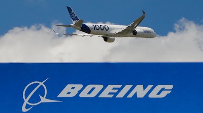 In this June 17, 2019, file photo, an Airbus A 350 - 1000 performs a demonstration flight at Paris Air Show in Le Bourget, east of Paris, France. The owner of Air India announced a deal Tuesday Feb.14, 2023 to buy 250 Airbus jets, including A350 wide-body planes and A320neo single-aisle planes in a deal worth billions of dollars. Air India, owned by Tata Group, is reportedly considering a similar order for Boeing as part of expansion efforts.