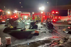 In this photo released by Contra Costa County Fire Protection District, firefighters work the scene of a fatal accident involving a Tesla and Contra Costa County fire truck early Saturday morning, Feb. 18, 2023, in Contra Costa, Calif.