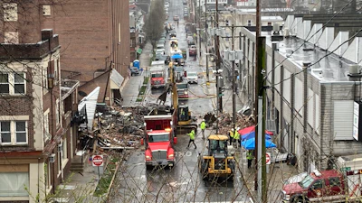 Emergency responders and heavy equipment are seen at the site of a deadly explosion at a chocolate factory in West Reading, Pennsylvania, Saturday, March 25.