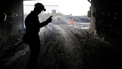 A mine employee stands in the entry of the Signal Peak Energy's Bull Mountain mine in Roundup, Mont., on Nov. 9, 2010.