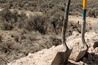 Exploration drilling continues for Permitting Lithium Nevada Corp.'s Thacker Pass Project on the site between Orovada and Kings Valley, in Humboldt County, Nev., shown beyond a driller's shovels in the distance, Sept. 13, 2018.