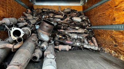 This photo provided by the Phoenix Police Department shows stolen catalytic converters that were recovered after detectives served a search warrant at a storage unit in Phoenix, May 27, 2022.