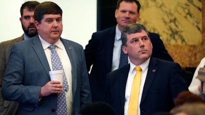 Republican Sens. Jeremy England, R-Vancleave, left, and Daniel Sparks of Belmont, listen as the Senate Clerk tallies the vote on a bill that would place new restrictions on car manufacturers for opening brick-and-mortar car dealerships, following a long floor debate in the Chamber at the Mississippi Capitol in Jackson, Thursday, March 2, 2023.