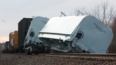 A Norfolk Southern cargo train car leans off the tracks after derailing in Clark County, Ohio, March 4, 2023.