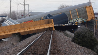 Multiple cars of a Norfolk Southern train lie toppled after derailing at a train crossing with Ohio 41 in Clark County, Ohio, March 4, 2023.
