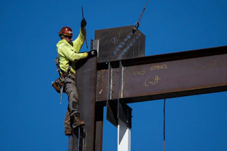 An ironworker guides a beam during construction of a municipal building in Norristown, Pa., Wednesday, Feb. 15, 2023.