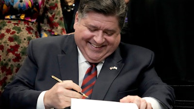 Illinois Gov. J.B. Pritzker sign the Paid Leave For All Workers Act, Chicago, March 13, 2023.