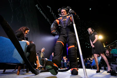 Axiom Space chief engineer Jim Stein demonstrates a prototype spacesuit, Wednesday, March 15, 2023, in Houston.