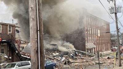 Emergency personnel work at the site of a deadly explosion at a chocolate factory in West Reading, Pa., Friday, March 24, 2023.