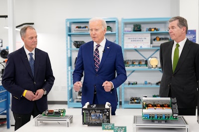 President Joe Biden tours semiconductor manufacturer Wolfspeed Inc., in Durham, N.C., Tuesday, March 28, 2023, with CEO Gregg Lowe and North Carolina Gov. Roy Cooper, right.