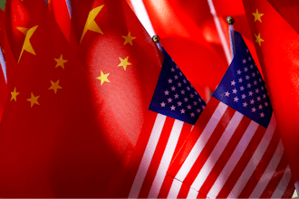 The flags of the U.S. and Chinese are displayed together on top of a trishaw in Beijing on Sept. 16, 2018.
