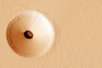 A hole in the surface of Mars, spotted by the HiRISE camera, reveals a cave below. Protected from the harsh surface of Mars, such pits are believed to be good candidates to contain Martian life, making them prime targets for possible future spacecraft, robots and even human interplanetary explorers.