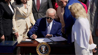 President Joe Biden signs into law H.R. 4346, the CHIPS and Science Act of 2022, at the White House in Washington, Aug. 9, 2022. Biden is set to tour a clean energy technology manufacturer in Minneapolis on Monday, April 3, 2023, as part of his effort to highlight his investment agenda ahead of an expected reelection campaign. ()