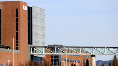 Workers walk on a skybridge to and from a large Intel facility in Hillsboro, Ore., on March 17, 2023.