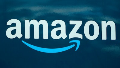 An Amazon logo appears on a delivery van, Oct. 1, 2020, in Boston. Amazon’s total injury rate for warehouse workers took a dip last year, but injuries were still worse than they were in 2020, according to an analysis released Wednesday, April 12, 2023, by a coalition of labor unions.