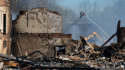 Firefighters pour water on an industrial fire in Richmond, Ind., Thursday, April 13, 2023.