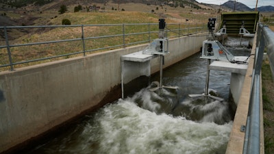 Water flows through an irrigation canal with a turbine at Ralston Reservoir in Arvada Colo. on Thursday, April 13, 2023.