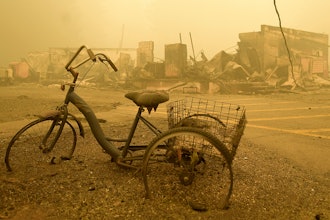 A trike stands near the burnt remains of a building destroyed by a wildfire near the Lake Detroit Market in Detroit, Ore., Sept. 11, 2020.