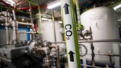 A liquid carbon dioxide pipe is labeled in a production room of The Grand Tier luxury apartment building, where the carbon byproduct of a natural gas fired water boiler is repurposed for industrial sale, Tuesday, April 18, 2023, in New York.