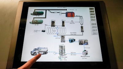 Brian Asparro, chief operating officer of CarbonQuest, points to a delivery truck on a touch screen display outlining the process from which liquid carbon dioxide is produced as a byproduct of a natural gas fired water boiler in the basement of The Grand Tier luxury apartment building, Tuesday, April 18, 2023, in New York.